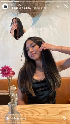 a woman sitting at a table with long hair