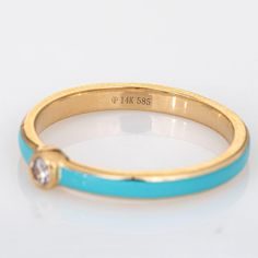 Stylish turquoise & diamond stacking band crafted in 14 karat yellow gold.   1 round brilliant cut diamonds total an estimated 0.03 carats (estimated at H-I colour and SI2 clarity).   The enamelled band is a striking turquoise colour with a small diamond to the centre of the band. The low rise ring (2mm - 0.07 inches) sits comfortably on the finger. Great worn alone or stacked with your fine jewellery from any era.   The ring is in very good condition.   Particulars:  Weight: 1.3 grammes  Stones Turquoise Enamel Anniversary Ring, Turquoise Enamel Ring For Anniversary, Gold Diamond Turquoise Ring For Anniversary, Fine Gold Turquoise Ring With Diamond Accents, Gold Diamond Turquoise Ring, Gold Turquoise Diamond Ring, Diamond Stacking Band, Stacked Diamond Bands, Stacking Bands