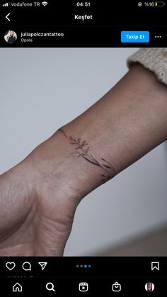 a person's arm with a small tattoo on it