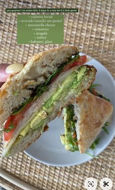 a sandwich with avocado and tomato on it is sitting on a white plate