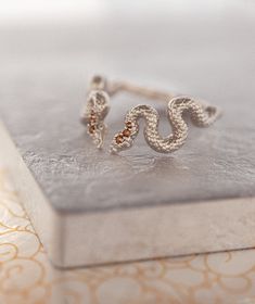 Fab and Sophisticated snake band in Bohemian Chic style. The snake texture inspired by mystical alchemical Ouroboros snake, which is one of the traditional infinity symbols. It has comfort fit and you won't want to take it off! About this item: -Flipped brown diamonds. 0.05 total carat weight -Solid 10K Rose/Yellow/White Gold OR -Solid 14K Rose/Yellow/White Gold OR -Solid 18K Rose/Yellow/White Gold PLEASE NOTICE: This price is for the ring's sizes up to 8, if you need a bigger size > contact Silver Snake-shaped Wedding Ring, Silver Snake Shape Wedding Ring, Silver Snake-shaped Fine Jewelry Ring, Silver Snake Ring Fine Jewelry, Fine Jewelry Silver Snake Ring, Unique Snake-shape Wedding Ring, Unique Yellow Gold Snake-shaped Ring, Elegant Handmade Snake Ring, Ouroboros Ring