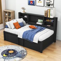 a bed sitting on top of a hard wood floor next to a book shelf filled with books