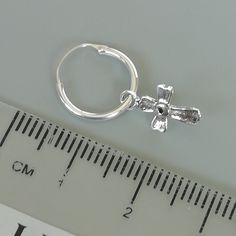 Comes with a detachable cross charm. The charm is multipurpose and can be used with a neck or bracelet chain too. Dimension: Hoop- 12 x 1.2 mm Cross: 7 x 12 mm Weight: 0.70gm Price listed is for a PAIR of hoops. These earrings are made of 925 hypoallergenic sterling silver and comes with a 925 stamp. Can be packaged in a gift box. I can include a personal message from you if needed You are welcome to contact me at... bhavnakwintra1956@gmail.com For more beautiful pieces from my shop, please brow Adjustable Hoop Sterling Silver Jewelry, Adjustable Small Hoop Metal Huggie Earrings, Nickel-free Small Hoop White Gold Jewelry, Nickel-free White Gold Small Hoop Jewelry, Nickel-free Small Hoop Sterling Silver Earrings, Small Hoop Nickel-free Sterling Silver Earrings, Nickel-free Small Hoop Earrings In Sterling Silver, Small Hoop Sterling Silver Nickel-free Earrings, Adjustable Nickel-free Round Huggie Earrings