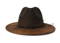 The Thiago hat form the Cartagena CollectionType: Center Dent Wide Brim FedoraSpecifications: Adjustable Size- With a tie of a knot, adjust the fit of your hat to the ideal size from 21 ¼ to 23 ¼ inches.Dimensions: Wired Brim: 2 7/8", Crown: 4"Color: Distressed Brown, Sun bleached for 32 hrs.Materials: 65% Cotton, 35% Polyester Black- Genuine Leather Cord Natural Ringneck Pheasant Feather Green Jasper StoneOrigin: All of our hats begin in Ecuador as the body is molded, then completed in Tucson, Adjustable Distressed Brimmed Hat, Distressed Brown Brimmed Hat, Distressed Flat Brim Hat With Adjustable Fit, Vintage Distressed Fedora Hat, Distressed Adjustable Flat Brim Hat, Adjustable Distressed Fedora With Flat Brim, Distressed Adjustable Fedora For Rodeo, Vintage Distressed Fedora Hat Bands, Distressed Brown Adjustable Hat With Flat Brim