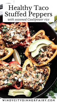 healthy taco stuffed peppers with seasoned cauliflower rice in a cast iron skillet