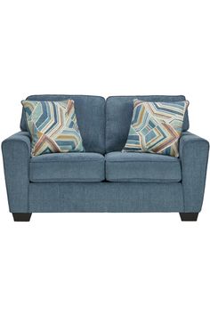 a blue couch with two pillows on it