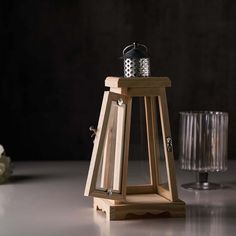 a small wooden lantern sitting on top of a table