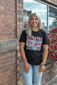 The Vintage Racing Club Graphic Tee in black is a must-have for enthusiasts of classic motorsports and timeless style. Made entirely from 100% cotton, this tee provides superior comfort and breathability, perfect for daily wear or special occasions related to car culture. The fabric is crafted from 30 singles jersey, noted for its fine texture and luxurious feel, while the 150 GSM weight ensures it remains light yet durable enough to withstand regular use and washing. Featuring a striking vintage racing club graphic, the design captures the thrill and nostalgia of old-school racing. Printed in the USA, the graphic is applied using high-quality techniques to ensure it remains vibrant and detailed over time, reflecting a deep appreciation for the racing heritage. The tee is available with ei Black Racing T-shirt With Letter Print, Black Racing Style T-shirt With Letter Print, Black Racing Style T-shirt With Logo Print, Black Racing Tops With Logo Print, Black Racing Fan Merchandise T-shirt, Racing Club, Black Backdrops, Car Culture, Vintage Racing