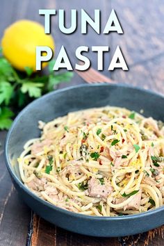 tuna pasta in a blue bowl with parsley on the side