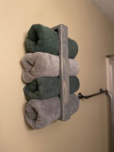 towels are hanging on the wall in front of a towel dispenser and mirror