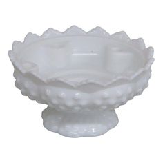 a white glass bowl with scalloped edges