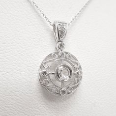 This beautiful necklace would make the perfect gift for a bride-to-be on her wedding day. Made of 14K white gold, this beautiful filigree pendant has a 2.54mm rose cut diamond bezel set into its center. Surrounded by milgrained swirls and accented by four additional diamonds, this necklace is versatile enough for dressing up or everyday wear. MEASUREMENTS - PENDANT: 11.75mm diameter - CHAIN: 18" 14KWG WEIGHT: 2.5g STONES: 8x diamonds (0.20ctw) Victorian Diamond Necklace With Single Cut Diamonds For Wedding, Victorian Wedding Necklace With Single Cut Diamonds, Victorian Wedding Necklaces With Single Cut Diamonds, Oval Diamond Pendant Necklace With Rose Cut, Elegant Oval Filigree Necklace, Victorian Diamond Necklace With Single Cut Diamonds For Anniversary, Wedding Necklace With Diamond Accents, Medallion Shape, Oval Diamond Filigree Necklace, Wedding Necklace With Diamond Accents And Medallion