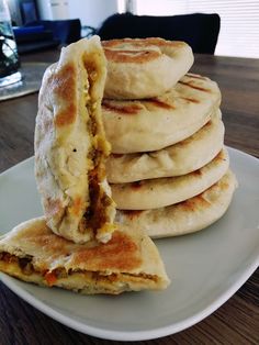 a stack of pancakes sitting on top of a white plate