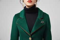 "This stunning dark green wool coat for womens is beautifully fitted and tailored for a classic, feminine design. There is a brooch decoration on lapels.The long wool coat features dark green, a slim fitting bodice with long sleeves and fitted waist leading into a long,flowing skirt coat. Details : * dark green wool blend fabric with polyester lining * two pockets * button closure in front * lapel collar * long sleeves * brooch decoration * winter coat, spring coat, womens coat * mid calf length Elegant Tailored Dark Green Blazer, Elegant Green Blazer With Lapel Collar, Elegant Green Wool Outerwear, Elegant Formal Green Outerwear, Elegant Green Formal Outerwear, Elegant Green Wool Coat, Elegant Wool Coat With Suit Collar For Office, Elegant Green Long Wool Coat, Elegant Green Blazer For Fall