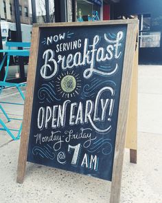 a chalkboard sign on the sidewalk advertising breakfast and open early monday, 7 am