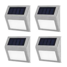 four solar powered motion sensor lights on white background