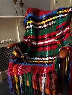 a colorful blanket sitting on top of a wooden chair