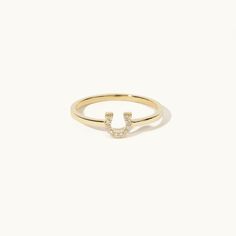 a gold ring with the letter j on it's side and diamonds in the middle