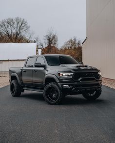 a black truck parked in front of a building