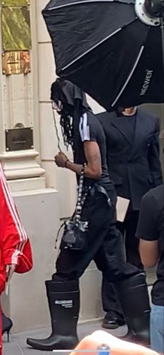 a man with an umbrella walking down the street