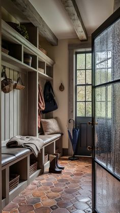 the inside of a mud room with stone flooring