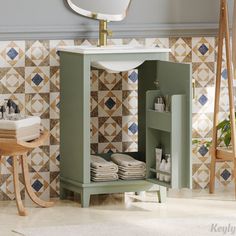 a bathroom with a sink, mirror and towel rack on the wall next to it