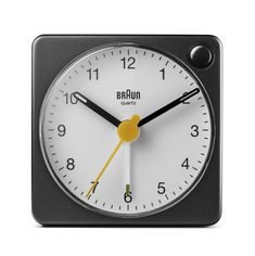 a black and white clock with yellow hands on it's face, showing the time