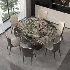 a round marble dining table surrounded by white chairs