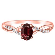 a rose gold ring with an oval red stone and diamonds