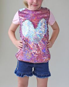 This fun, reversible sequined shirt is your fashion girls staple for the spring or summer! The cotton back provides breathable comfort, while the colorful reverse side is sequined flippin' fun!Front: 100% polyesterBack: 100% cottonHand wash; hang dry Sequin Tshirt, Sequin Mask, Chemise Rose, Sequin Pants, Sequin Shirt, Pink And Silver, Sequin Shorts, Girls Blouse, Pink Sequin