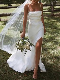 a woman in a wedding dress holding a bouquet