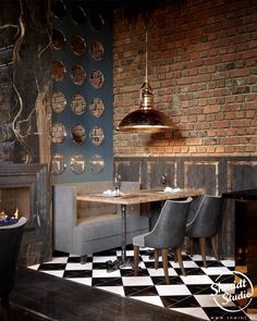 a restaurant with black and white checkered flooring, brick walls and fireplaces