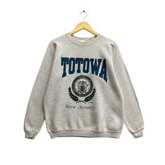 "Code : p/66 Vintage 90s Totowa New Jersey Grey Sweatshirt Size Large Totowa Crewneck Totowa New Jersey Sweater Pullover Totowa New Jersey Print Logo  Size on Tag :  L Details Measurement  Arm Pit to Arm Pit : 23\"inches Back Collar to Hem : 26\"inches Condition :  Great Vintage Condition(Used Clothing).No Holes And No Stain.Please refer pictures detail.‼️" Vintage Fall Sweater With Letter Print, Vintage Letter Print Sweater For Fall, Vintage Sweater With Letter Print And Long Sleeves, Vintage Letter Print Winter Sweater, Vintage Long Sleeve Sweater With Letter Print, Vintage Letter Print Sweater For Winter, 90s Style Crew Neck Top For Fall, Vintage Winter Tops For College, Vintage Crew Neck Winter Top