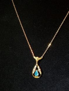 "This Blue Topaz Lavaliere was made in C-1910-1920 which is the time that they made more Lavaliere. It is in a tear drop shaped with open metal work with each side adorn with Gold & Rose Gold ornate design. At the bottom center is a prong set Blue Topaz also shaped in a tear drop. Above is an ornate winged bar with 2 small rings that have the chain attached. The chain is a gold link chain with a hallmark on 1 ring that reads \"1/20th 12K GF\". This necklace was purchased at an Estate Sale an Antique Gold Pear-shaped Jewelry, Antique Pear-shaped Gold Jewelry, Exquisite Gold Pear-shaped Necklace, Exquisite Pear-shaped Gold Necklace, Exquisite Gold Necklace For Collectors, Victorian Pear-shaped Gold Jewelry, Gold Hallmarked Pear-shaped Necklace, Gold Pear-shaped Hallmarked Necklace, Victorian Gold Teardrop Necklace