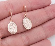 Dainty Oval Virgin Mary earrings in sterling silver, 14K gold filled and rose gold filled. Perfect for a Easter gift! Super dainty and wonderful for everyday wear! EARRING DESCRIPTION: - Oval Virgin Mary charm 14mm - sterling silver, gold filled and rose gold filled - Ear wires in sterling silver, gold filled and rose gold filled - Comes with plastic ear backs for a secure fit - Handmade and packaged beautifully for you! - - - - - - - - - - - - - - - - - - - - MATERIALS: - 14K Gold Filled: Gold Oval 14k Gold-filled Jewelry For Anniversary, Tarnish Resistant Sterling Silver Oval Earrings, Hallmarked Oval Rose Gold Earrings, Oval Rose Gold Hallmarked Earrings, 14k Gold Filled Rose Gold Earrings For Anniversary, 14k Gold-filled Oval Earrings, Rose Gold 14k Gold-filled Earrings Gift, Rose Gold 14k Gold Filled Earrings For Anniversary, Rose Gold 14k Gold-filled Earrings For Anniversary