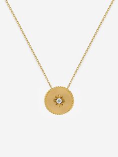 This stunning gold necklace with a small round pendant is carefully handcrafted from the finest 18 Carat Gold plated 925 Sterling Silver. The coin features our signature spheres all around and a small engraved North Star in the centre with a tiny stone that flawlessly simulates the look of an authentic diamond. 𝗣𝗥𝗢𝗗𝗨𝗖𝗧 𝗗𝗘𝗧𝗔𝗜𝗟𝗦 Metal: 18ct Gold Plated 925 Sterling Silver Stone: Cubic Zirconia Chain Length: 45cm (40cm+ 5cm extension) Pendant Shape: Coin with North Star Stone: Diamond North Star Necklace, Satin Noir, White Jewelry Box, Sparkling Stars, Necklace Layering, Diamond Simulant, Experience Gifts, Wedding Jewellery Necklace, White Jewelry