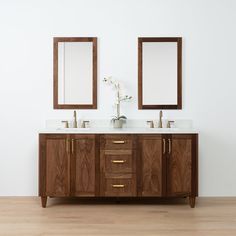 two mirrors are above the double sink vanity