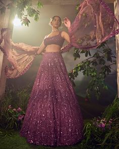 Featuring a argyle purple tulle lehenga embroidered fully by hand with various ornamental metallic sequences and Japanese bugle beads. It is paired with a scallop dupatta and a stylised blouse .From Aneesh Agarwaal's Ellora collection.DELIVERY TIMEPlease allow 8-12 weeks for your outfit to arrive.FABRIC DETAILSNetProfessional cleaning only. Luxury Purple Choli With Zari Weaving, Luxury Purple Lehenga With Motifs, Luxury Purple Designer Wear Lehenga, Luxury Designer Wear Purple Lehenga, Luxury Purple Lehenga For Festive Occasions, Luxury Purple Party Wear Lehenga, Luxury Fitted Purple Lehenga, Luxury Embroidered Purple Choli, Luxury Purple Sequined Dupatta