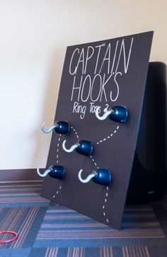 a black board with blue hooks attached to it that says captain hooks king kong