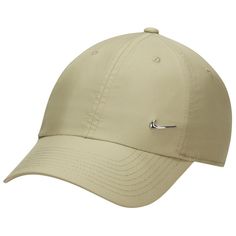 the nike golf hat is tan and has a black swooish on it