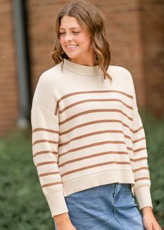 The Charlene Striped Drop Shoulder Crewneck Sweater will add a subtle pop of color to your closet this season! This camel striped lightweight knit top is warm and absurdly soft and instantly steps up any outfit. It features a modest crewneck, drop shoulders, long sleeves, and a cropped relaxed fit perfect for high waisted denim. Trust us, this is the kind of sweater you'll plan an outfit around! Style | Long Sleeve Color | Camel Stripe SIZING TIPS Fit | Loose Fit Stretch | None Model | True to S Overall Skirt, Professional Wardrobe, School Dresses, Church Dresses, Midi Short Sleeve Dress, Long Sleeve Maxi, Lightweight Knit, Crewneck Sweater, High Waisted Denim