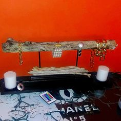 a table topped with candles and a piece of driftwood