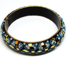 This is a truly unique and beautiful bohemian piece. Made of clay and is embellished with multi-coloured seed beads, coiled wire and is decorated with golden mirrored pieces. This bangle has INDIA carved on the inside, as per last photo. Bought from an estate sale, this piece is used and has minor signs of wear. Please look at the photos for a more accurate view of condition. Unique Beaded Bangle Bracelets For Festival, Bohemian Bangle Bracelets With Gold Beads, Bohemian Bangle Bracelet With Gold Beads, Bohemian Gold Beads Bracelets For Party, Bohemian Gold Beads Bracelet For Party, Bohemian Gold Beaded Bracelets For Party, Unique Embellished Festival Jewelry, Bohemian Gold Beaded Bangle Bracelets, Bohemian Beaded Bangle