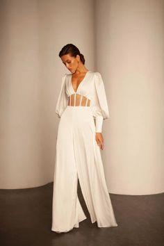 Satin bridal jumpsuit Modern wide leg bridal jumpsuit Palazzo pants wedding jumpsuit Minimalist V neck long sleeve bridal jumpsuit GAIA Name: Gaia Details: bridal jumpsuit «Gaia» features a V neck top with a sheer mesh corset on the waist and boning, long puff sleeves. The bottom of this jumpsuit Boho Wedding Jumpsuit The Bride, Wide Leg Bridal Jumpsuit, White Satin Jumpsuit Wedding, Bridal Corset Jumpsuit, Wedding Jumpsuit Lulus, Lesbian Bridal Outfit, Modern Wedding Jumpsuit, Bridal Overall, Corset Top Jumpsuit