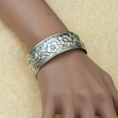 This vintage sterling silver flower cuff bracelet has wonderful workmanship and a beautiful floral design.  Done in a repoussé style, this delicate piece has raised flowers & leaves that decorate the entire piece.Gorgeous on its own, you can also stack it with other pieces to give a great boho look.Vintage CuffSterling SilverDimensions: Inside Diameter is 6 5/8" with a 5/8" gap by 7/8" widePlease read our shop policies prior to purchase. Thanks for looking and contact us with any questions. Silver Bracelet Cuff, Flower Cuff Bracelet, Flower Cuff, Vintage Silver Jewelry, Indie Jewelry, Floral Jewelry, Jewelry Lookbook, Funky Jewelry, Silver Bangle Bracelets