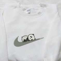 Introducing our Panda x Swoosh Embroidered Hoodie, a must-have for fashion enthusiasts! Made with soft, high-quality fabric, this hoodie features a unique panda and swoosh embroidery, adding a playful touch to your wardrobe. With its relaxed fit and cozy interior, it offers ultimate comfort for everyday wear. Whether you’re lounging at home or running errands, this hoodie is perfect for any occasion. Its trendy design and attention to detail make it an ideal gift for family members who app White Hoodie With Embroidered Graphics For Fall, Trendy Cotton Hoodie With Embroidered Graphics, White Fleece Sweatshirt With Embroidered Logo, Fleece Hoodie Sweatshirt With Embroidered Graphics, Embroidered Fleece Hoodie Sweatshirt, White Hoodie With Embroidered Graphics, White Crew Hoodie With Embroidered Graphics, Trendy Cotton Sweatshirt For Sports, White Long Sleeve Hoodie With Embroidered Graphics