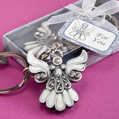 a key chain with an angel on it and a gift tag for $ 70 80