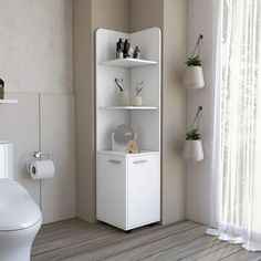 a white toilet sitting next to a bathroom sink in a room with wooden floors and walls