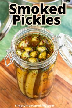 a jar filled with pickles sitting on top of a wooden table