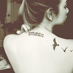 a woman with a bird tattoo on her back